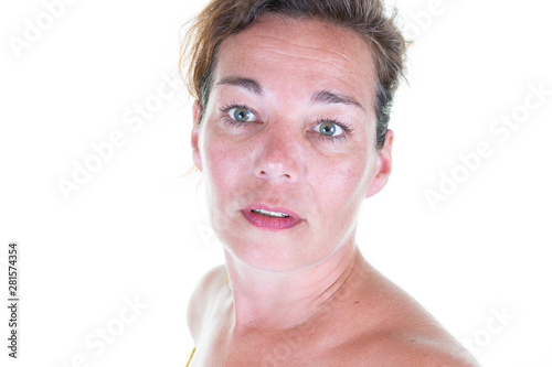 Close up portrait of beautiful middle aged woman standing by white wall