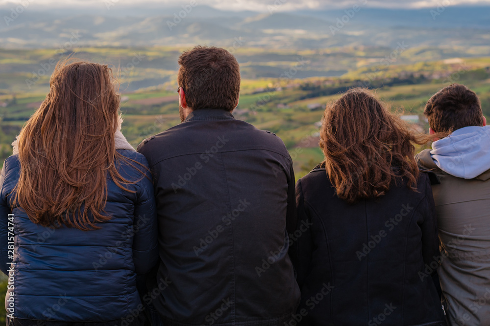 Christian worship and praise. Group of friends hugging outdoors at sunset. Christian worship and praise. Group of friends hugging outdoors at sunset.