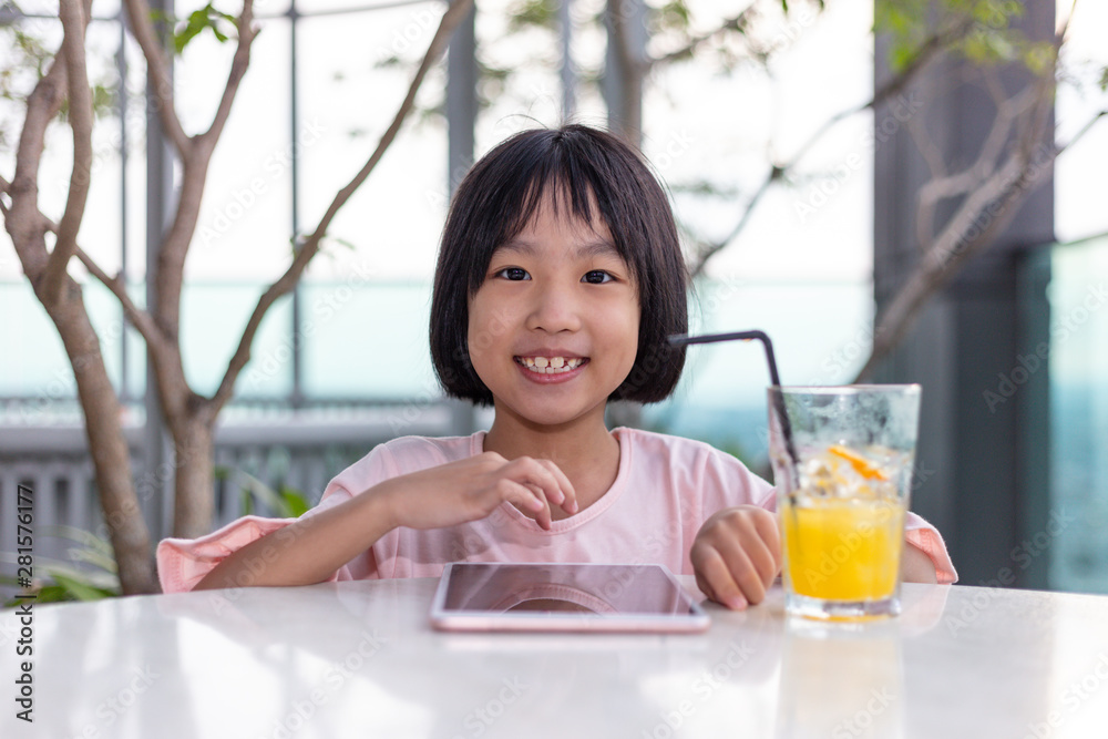 Asian Little Chinese Girl playing with tablet Asian Little Chinese Girl playing with tablet