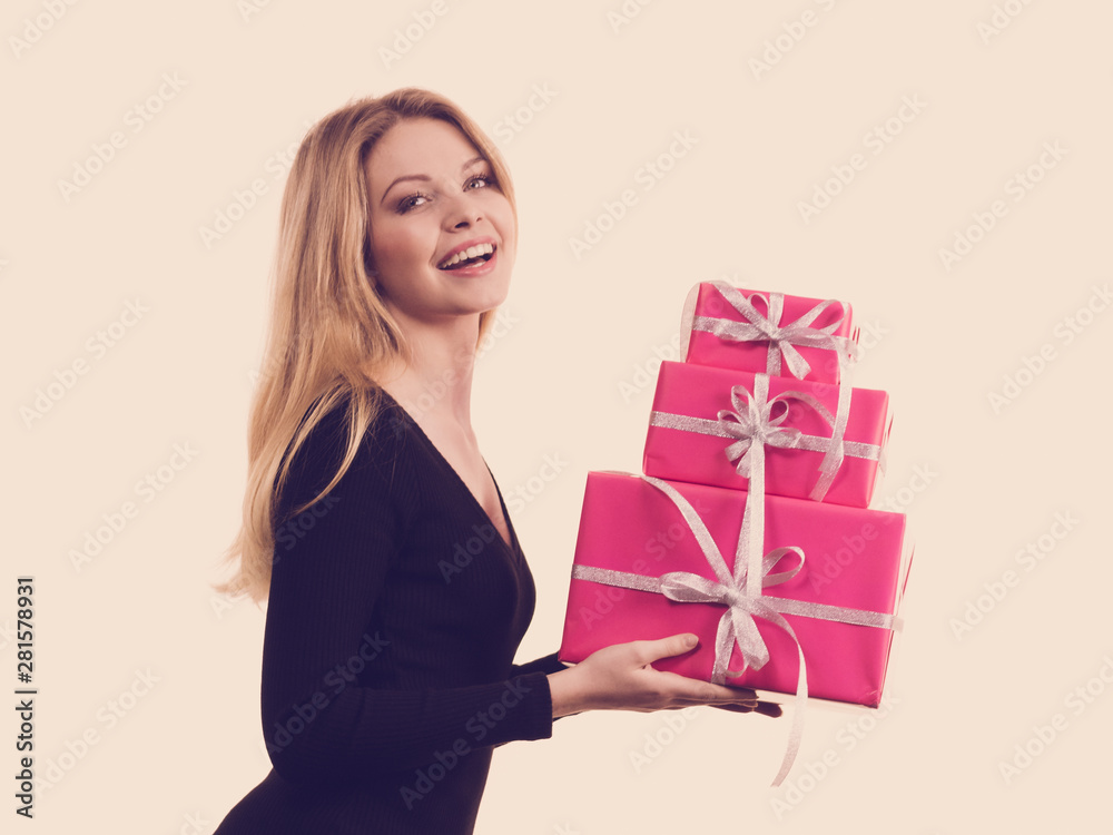 Girl holding stack of pink gift boxes Girl holding stack of pink gift boxes