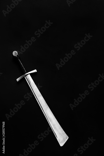Medieval falchion on a dark background. Place for text.