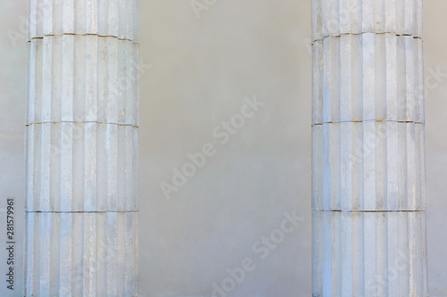 Two white columns on a wall background. Scenery.