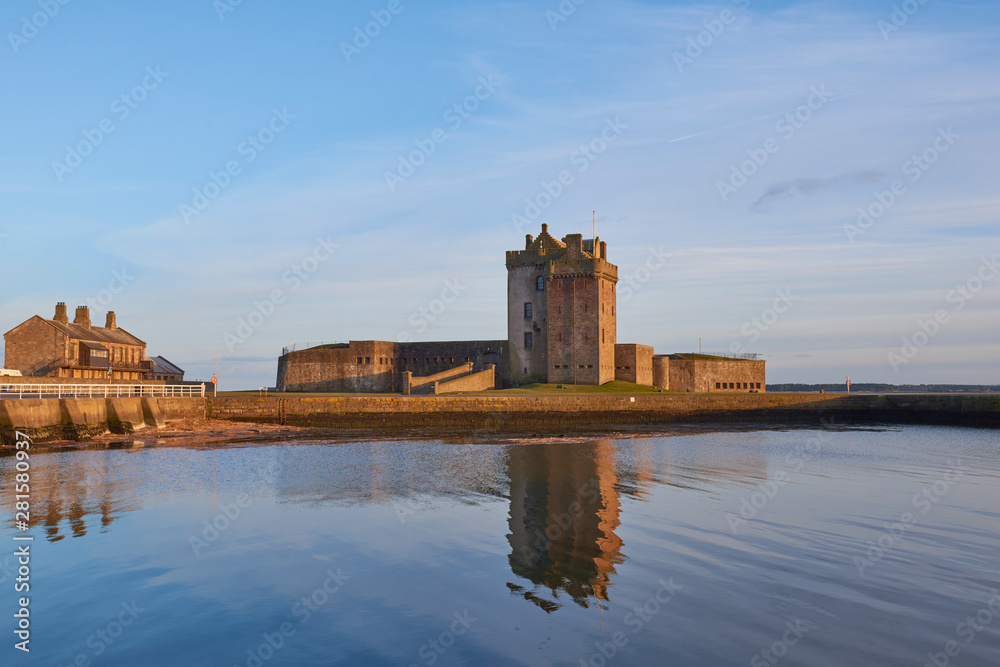 Broughty Castle and the Submarine Miners Living Range lit up in the Evening Sun at Broughty Ferry, Dundee in Angus, Scotland.