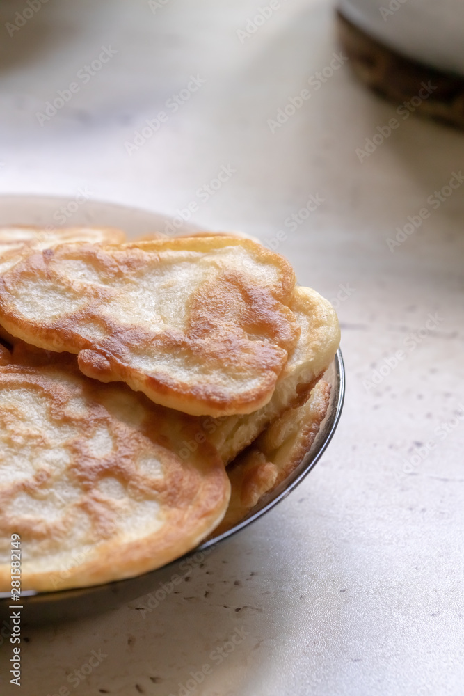 fresh pancakes on a glass dish. authentic homemade food. background backdrop.