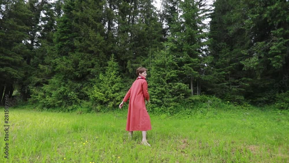 Girl in national dress whirl in a clearing Girl in national dress whirl in a clearing