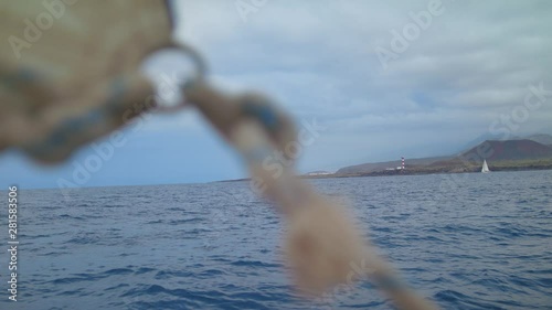 Sail is attached to the Kicking Strap Rope with a Marine Knot Sheet Weighs on Bow Pullpit Guard Rail Maritime Rope Knot tied aboard a Yacht Sailing Boat is Sailing along the calm Sea Waves  Shot URSA  photo