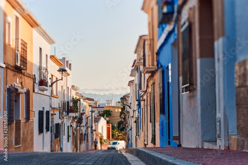Old town of Denia with narrow streets and coloured houses.