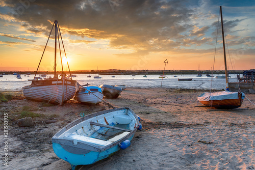 Fototapeta Beautiful sunset over boats on the beach at West Mersea,