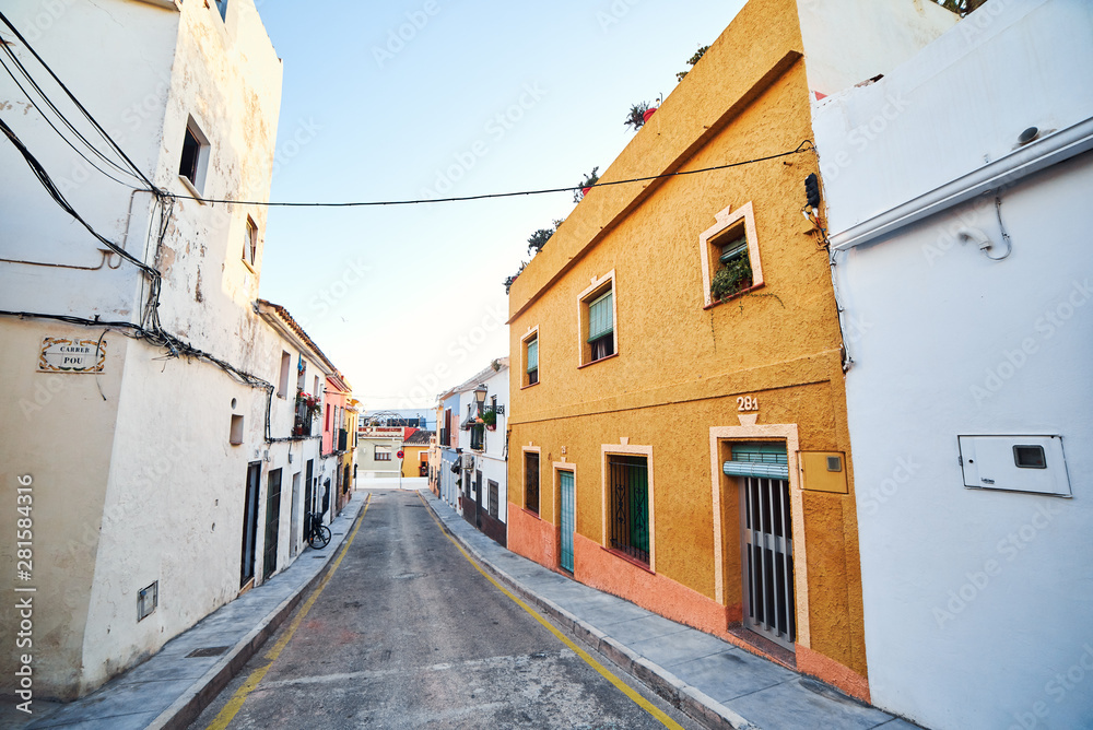 DENIA, SPAIN - JUNE 19, 2019: Old town of Denia with narrow streets and coloured houses.