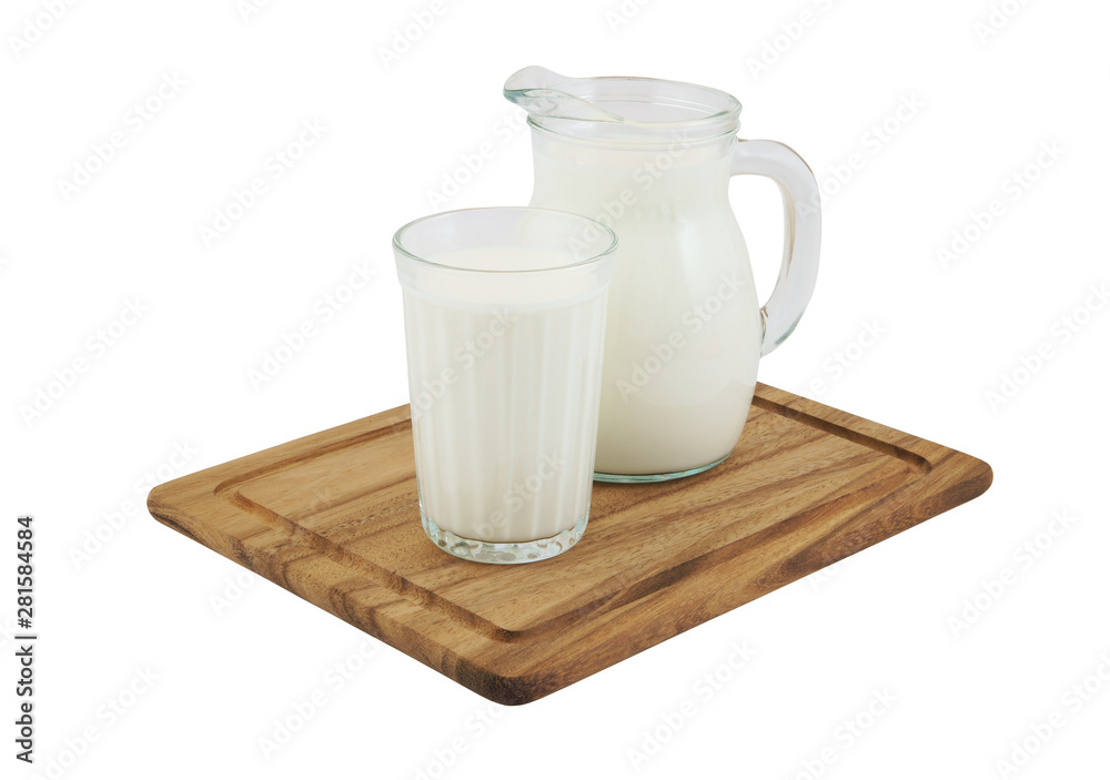 Milk in pitcher and glass on wooden board isolated Milk in pitcher and glass on wooden board isolated