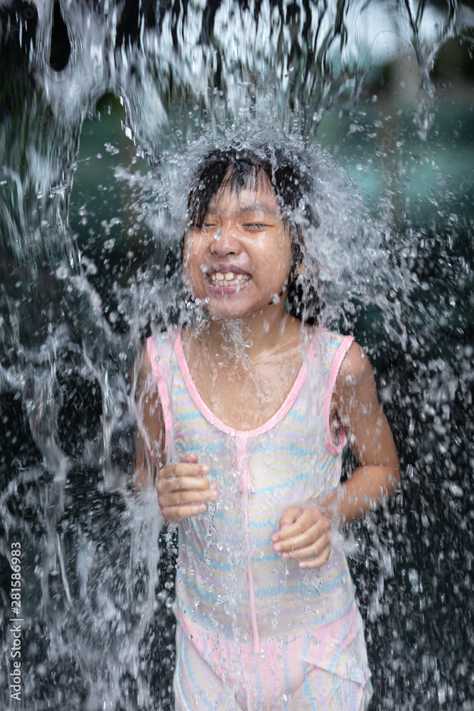 Fototapeta premium Asian Little Chinese Girl playing at water park