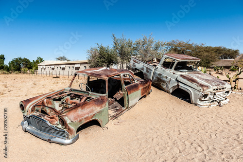 Wrecks of historic cars line the road in the town of Solitaire in the Khomas Region of Namibia.