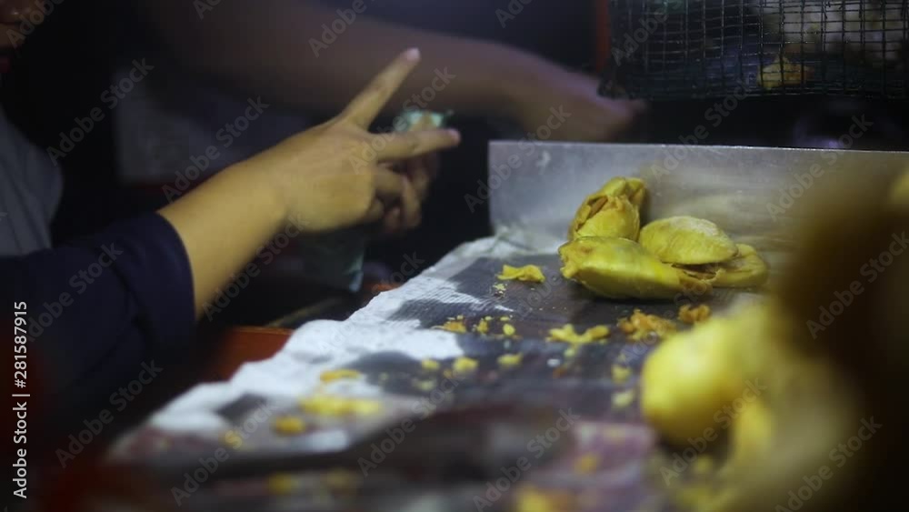 Shot of a street vendor cooking and selling their deep fried Indonesian