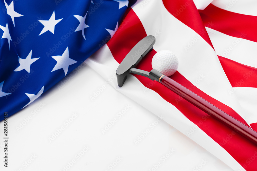Golf ball and club on American flag.