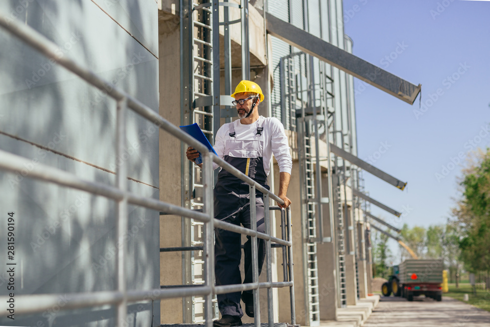 worker controlling grain load in factory