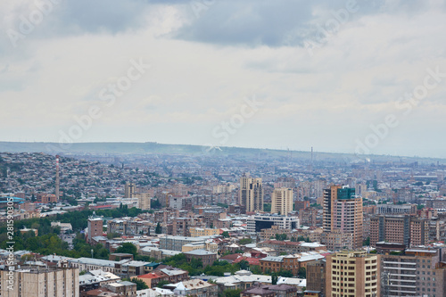 view of the city of Yerevan from the observation deck on a sunny day with clouds in the sky. © StockAleksey