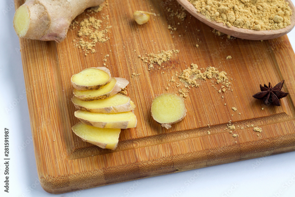 Fototapeta premium slices of fresh ginger on wooden background