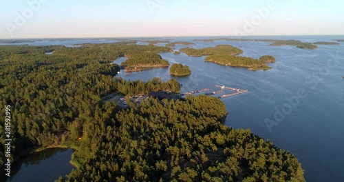 Aerial, drone shot towards a harbor and small islands, in the finnish Archipelago, on the Gulf of Finland, on a summer evening, at Baggo marina, on Skoldo, in Raasepori, Uusimaa, Suomi photo