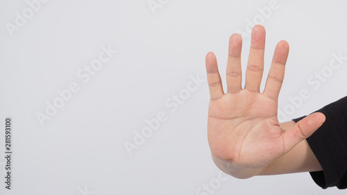 Male model is doing stop hand sign by showing five finger.