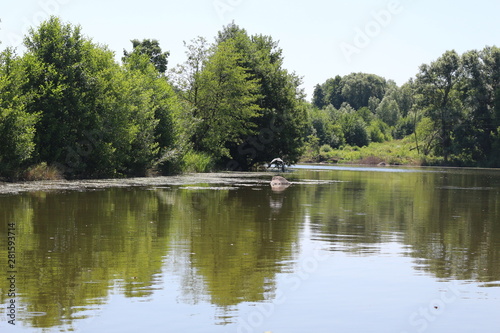  A calm river flows along the plain shores