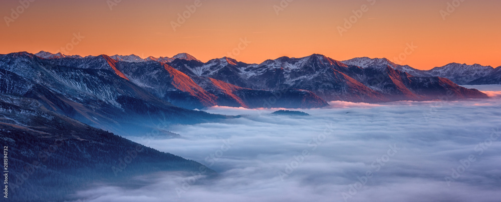 Amazing nature landscape, scenic panoramic top view of the Alps mountain range with clouds at sunset, outdoor travel background, Hohe Tauern national park, Carinthia, Austria