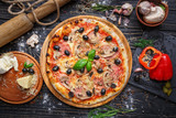 Exquisite pizza with ham, mushrooms and olives