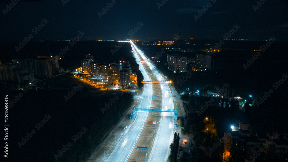 Hyperlapse timelapse of night city traffic fast cars driving around on the highway. Aerial view