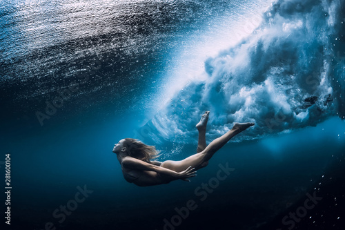 Woman swim underwater with ocean wave. © artifirsov