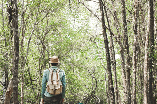 A man standing among mangrove forest with backpack Travel Lifestyle wanderlust adventure concept summer vacations outdoor alone into the wild Phang Nga Koh Yao Yai Thailand