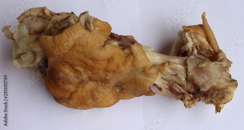 Boiled pig leg close-up on a white background.