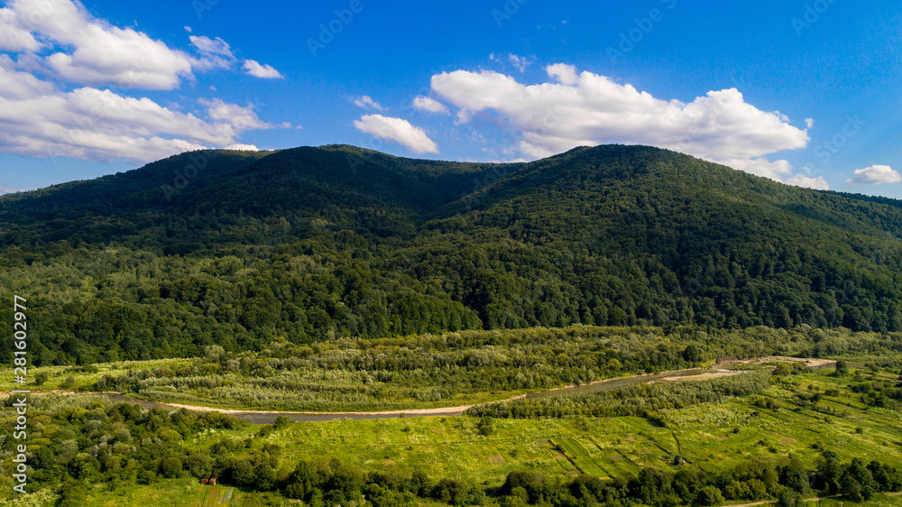 aerial shoot of green landscape in the mountains