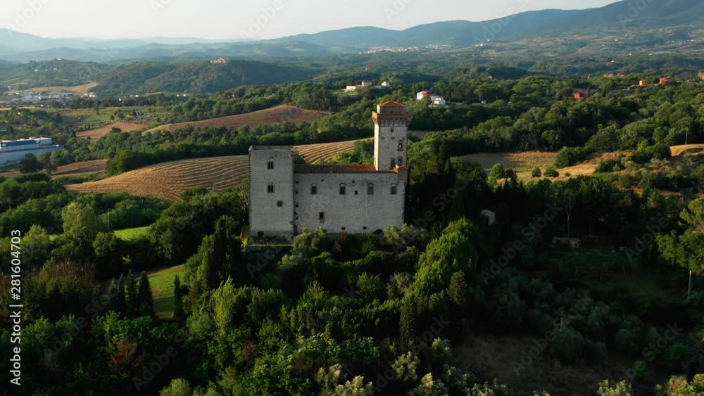 Aerial view of a beautiful old stone european building located on a hill in a picturesque place among the thickets and trees on a sunny summer day. Concept of tourism in ancient European places Aerial view of a beautiful old stone european building located on a hill in a picturesque place among the thickets and trees on a sunny summer day. Concept of tourism in ancient European places