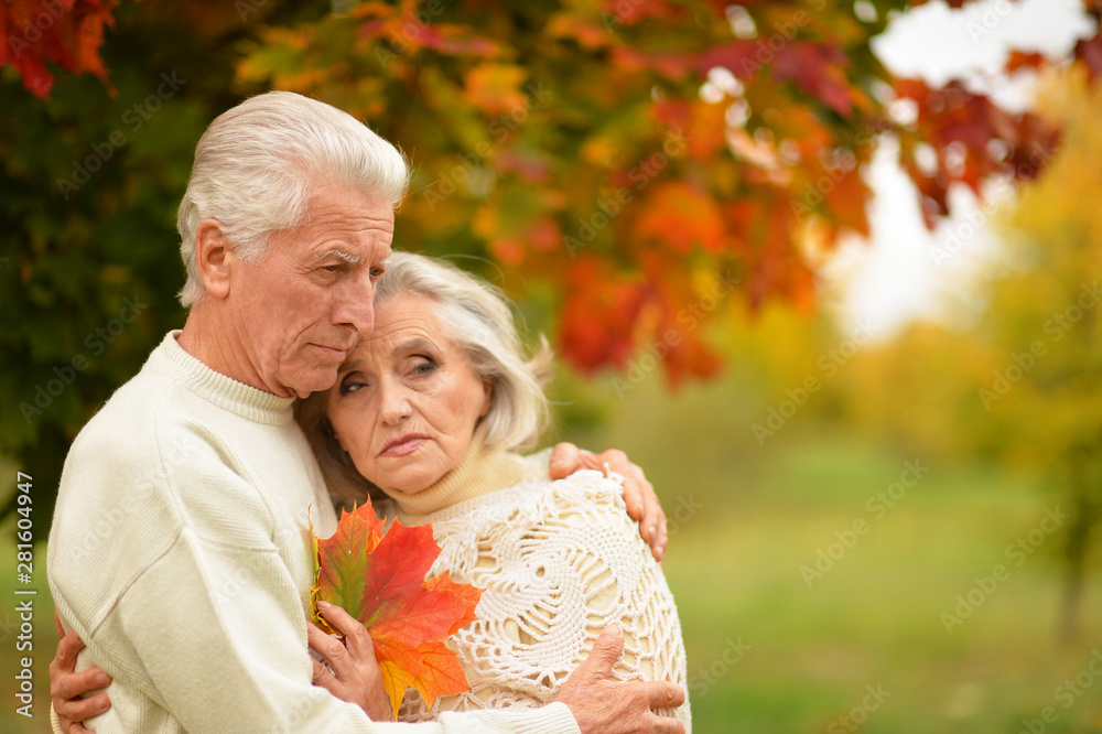 Portrait of sad senior couple in autumn park Portrait of sad senior couple in autumn park