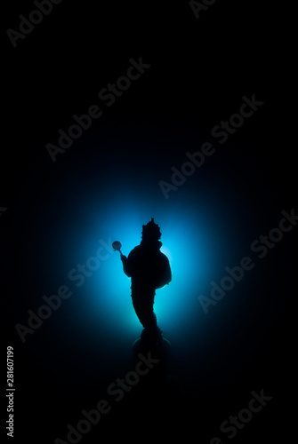 This shot of an underwater statue was taken at night by a scuba diver. The statue of the Guardian of the Reef has been backlit to create a silhouette effect. Negative space has been left deliberately