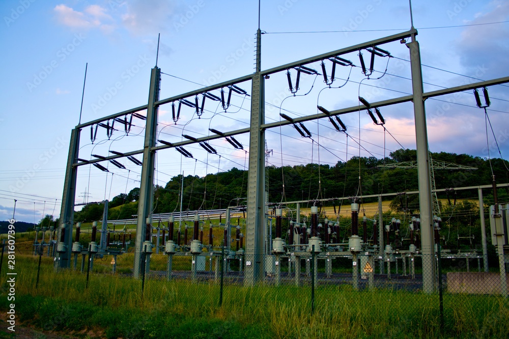 Obraz premium Power transformer in high voltage switchyard in modern electrical substation in Hesse, Germany