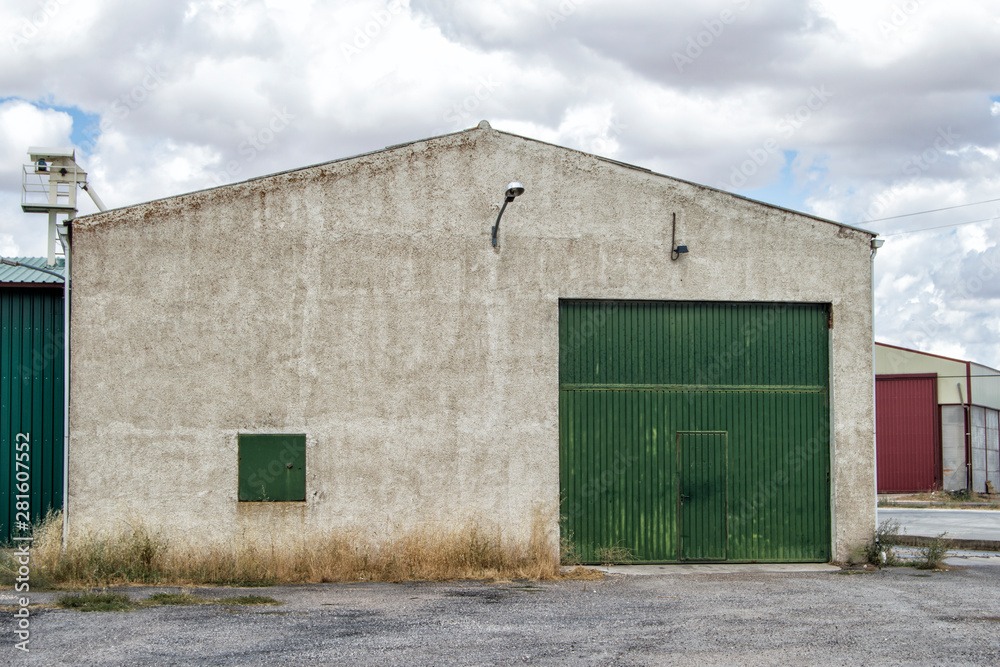 view of an exterior industrial warehouse in a polygon in Spain. view of an exterior industrial warehouse in a polygon in Spain.