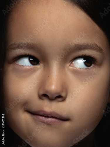 Close up portrait of little and emotional asian girl. Highly detail photoshot of female model with well-kept skin and bright facial expression. Concept of human emotions. Doubts  uncertainty  choice.