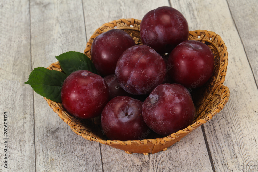 Plum heap in the wooden basket