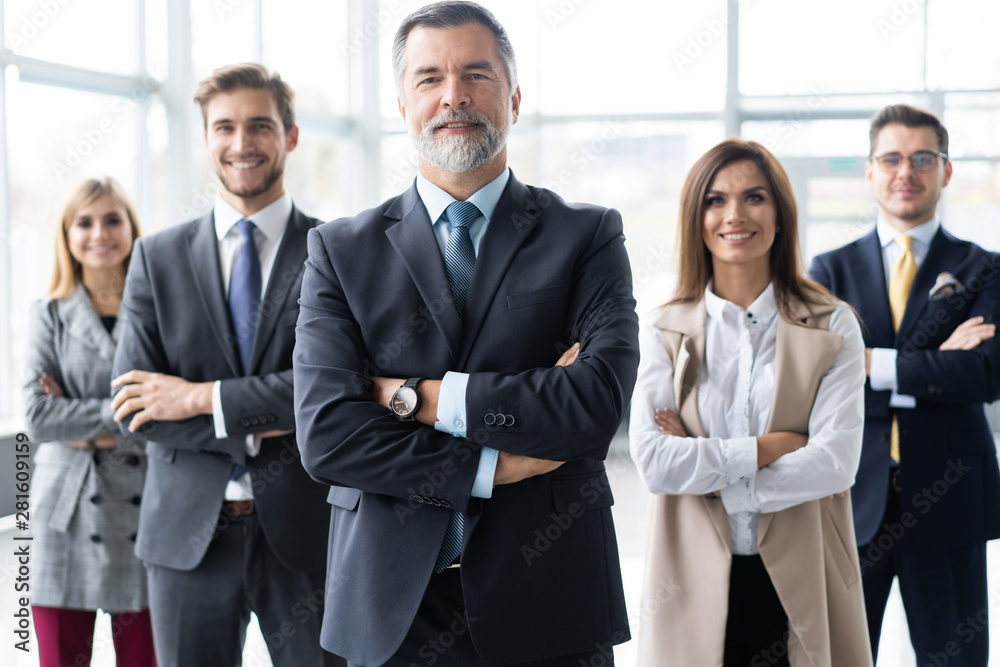 Happy business team with arms crossed at the office. Happy business team with arms crossed at the office.