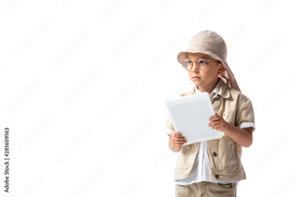 pensive explorer child in glasses and hat holding digital tablet and looking away isolated on white pensive explorer child in glasses and hat holding digital tablet and looking away isolated on white