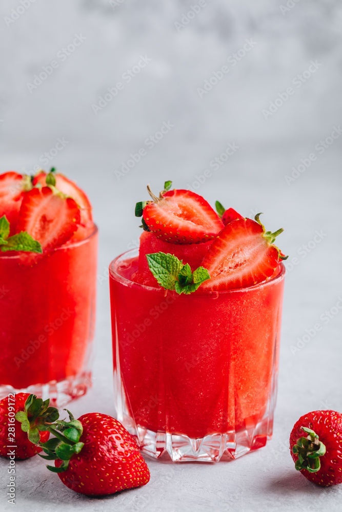 Fresh strawberry rhubarb and watermelon granita with mint on gray stone background Fresh strawberry rhubarb and watermelon granita with mint on gray stone background