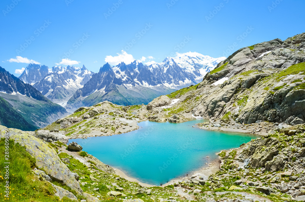 Beautiful landscape of French Alps. Turquoise Lake Blanc, in French Lac Blanc photographed on a sunny summer day with Mount Blanc and other high Alpine mountains in background. Amazing nature, France