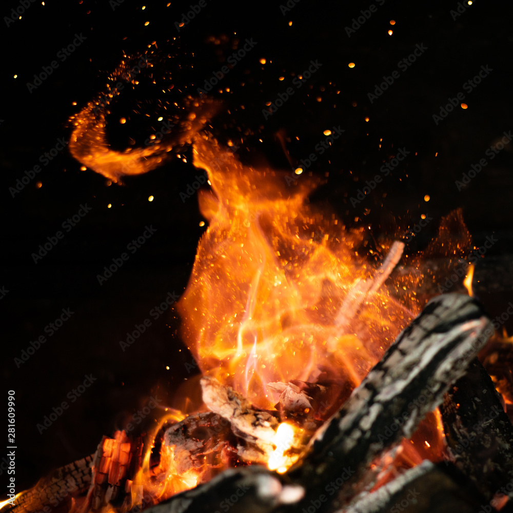 Fototapeta premium fire flames in bonfire stove isolated with balck