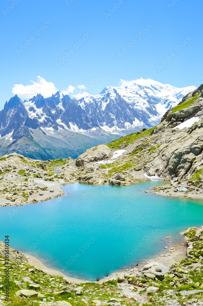 Stunning Alpine landscape with turquoise Lake Blanc, Lac Blanc photographed on a clear summer day. Mount Blanc and other high mountains in background. Beautiful France. Nature scenery