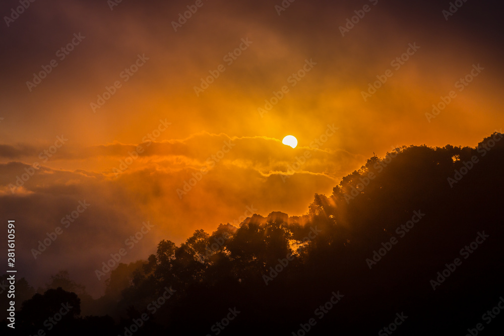 Obraz premium Dramatic sky of sunrise covered by cloud and fog