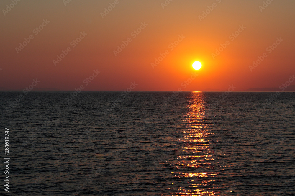 sunset over the sea, clear (reddish) sky