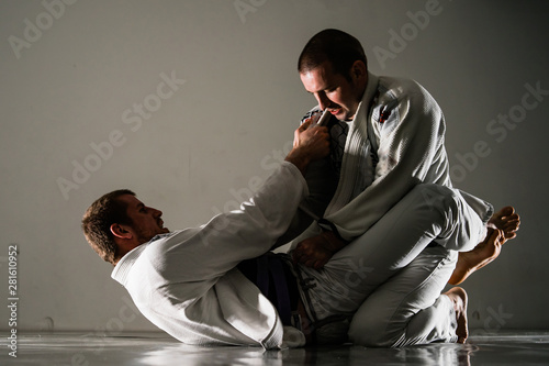 Cuadro en lienzo Brazilian jiu-jitsu BJJ training sparing on the tatami two fighters in guard pos