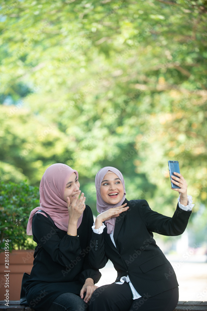 Muslim Business Women taking a Selfie. Outdoor Setting. Muslim Business Women taking a Selfie. Outdoor Setting.
