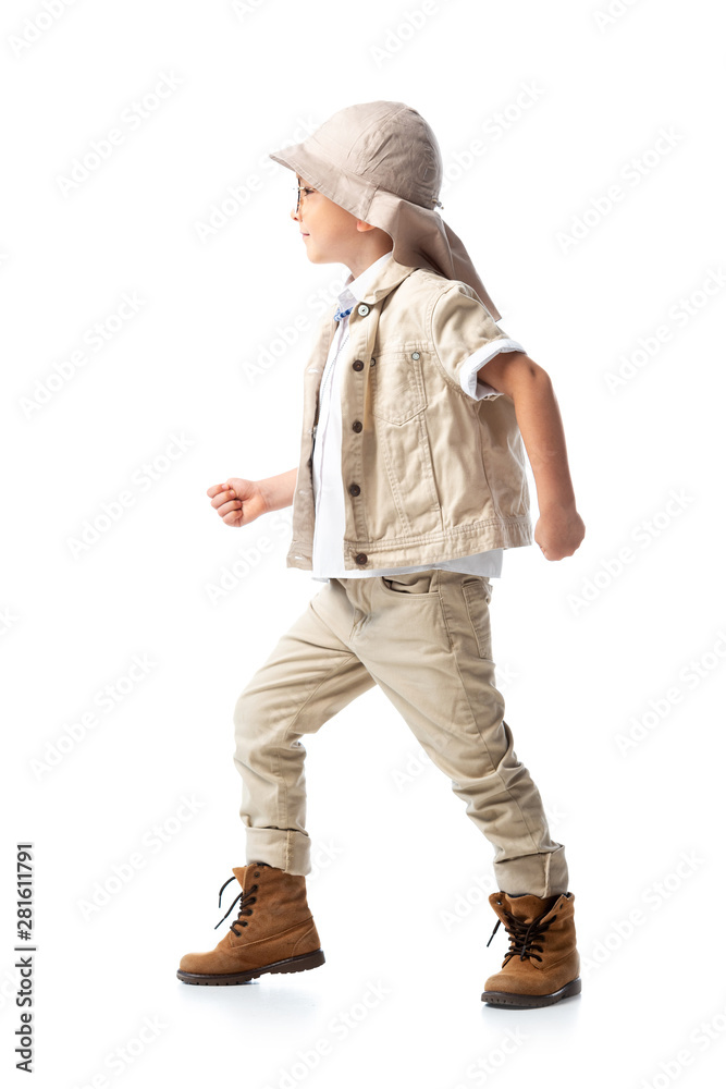 side view of explorer child in hat standing on white side view of explorer child in hat standing on white
