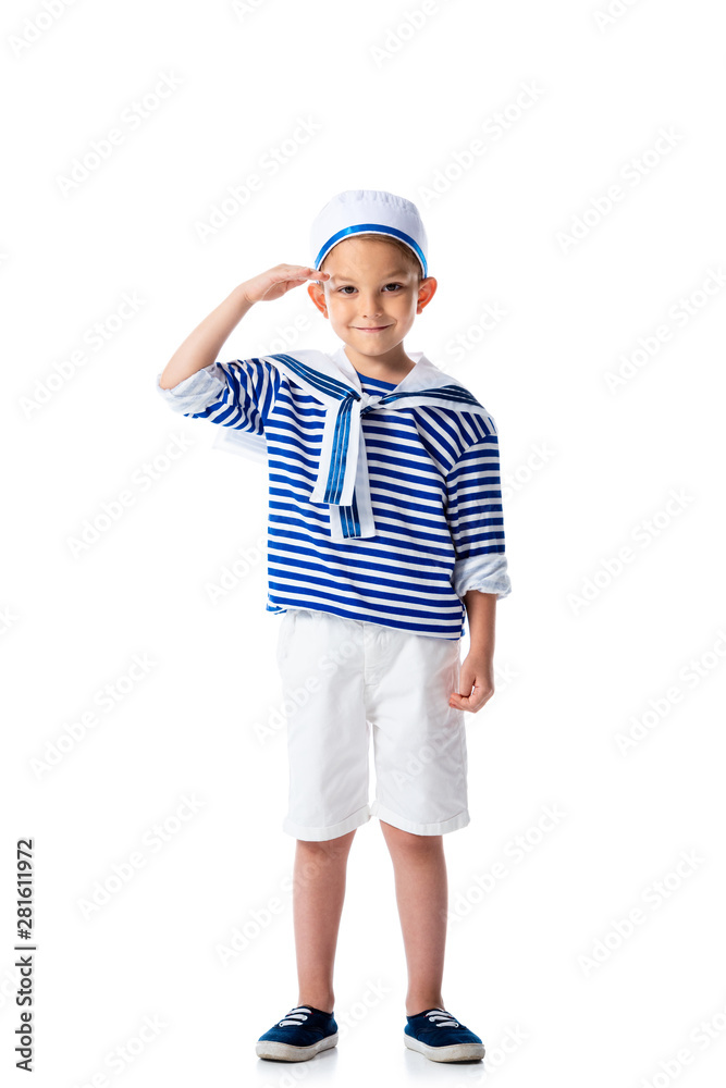 full length view of smiling preschooler child in sailor costume saluting and looking at camera isolated on white full length view of smiling preschooler child in sailor costume saluting and looking at camera isolated on white